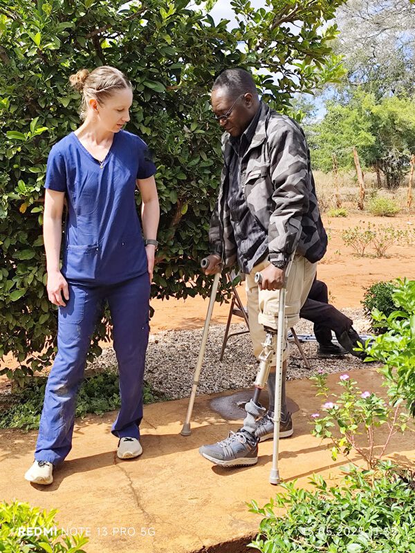 Hannah helping a patient walk